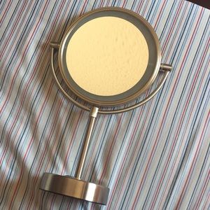 Rotating mirror with light